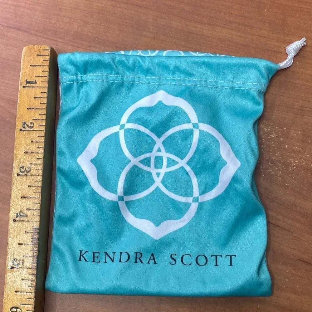 Kendra Scott jewelry bag in turquoise with white signature pattern drawstring